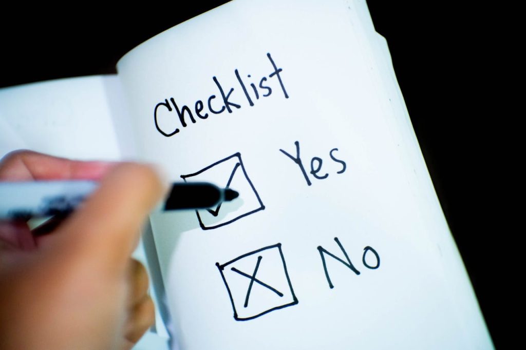 A notebook featuring a checklist with a marked Yes box, captured in a close-up shot.